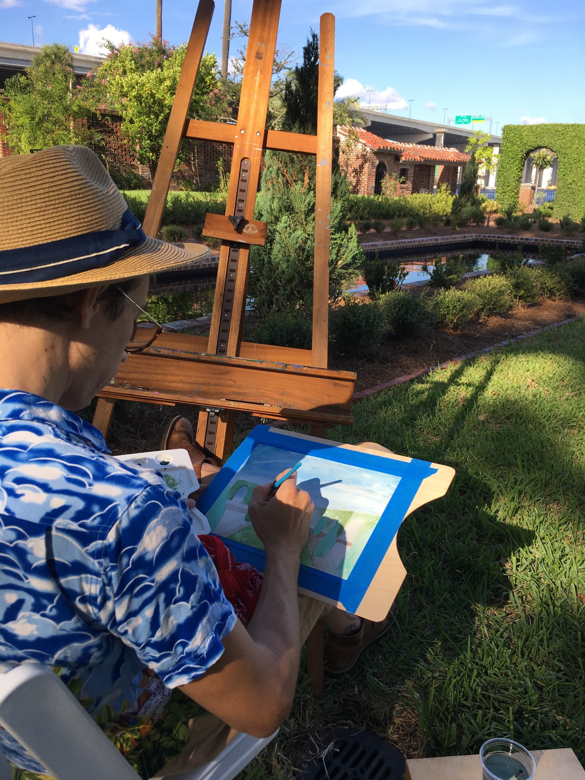 Artist working at an easel in the Cummer Gardens